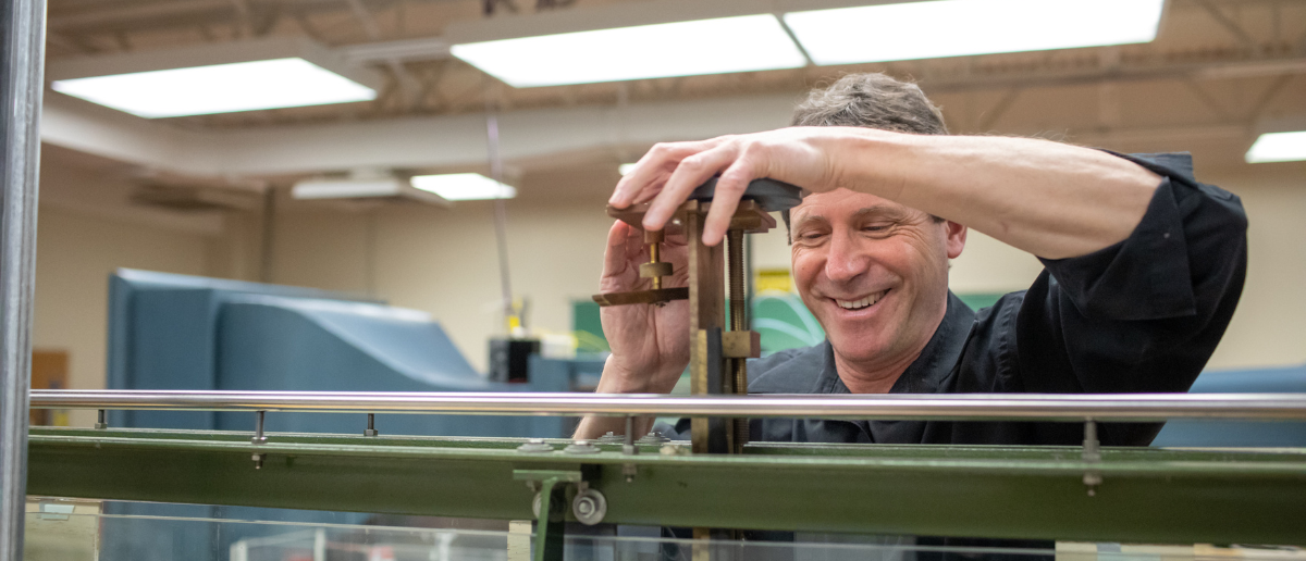 Man looking at device smiling